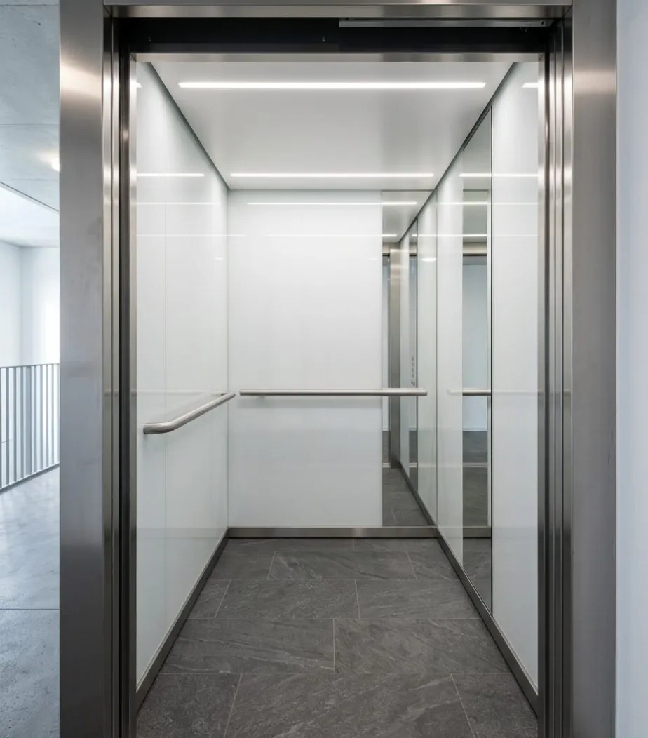 Modern lift cabin with white glass panels and LED ceiling