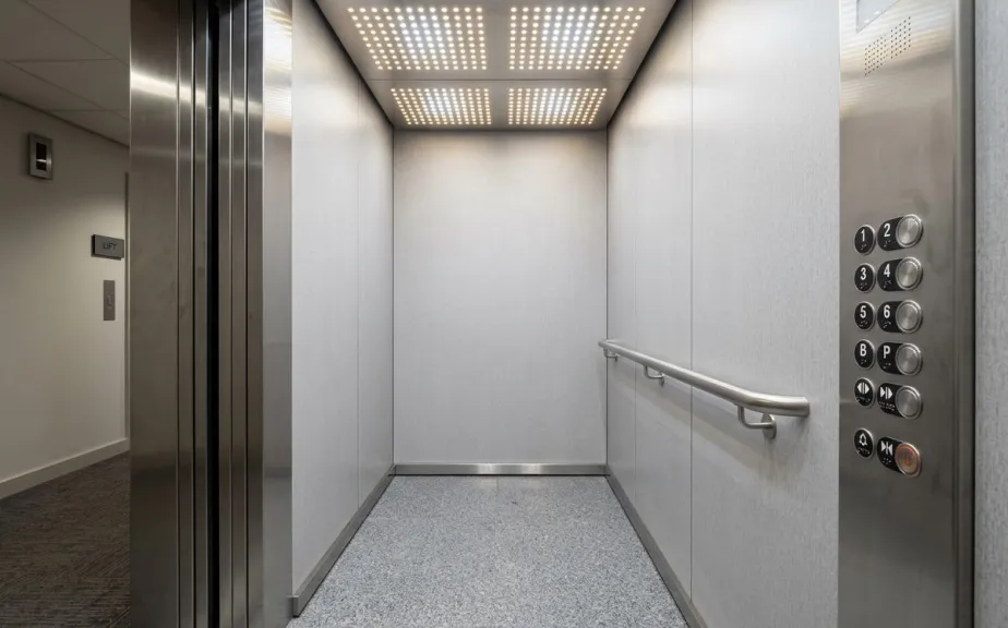 Refurbished office lift lobby with new stainless steel doors