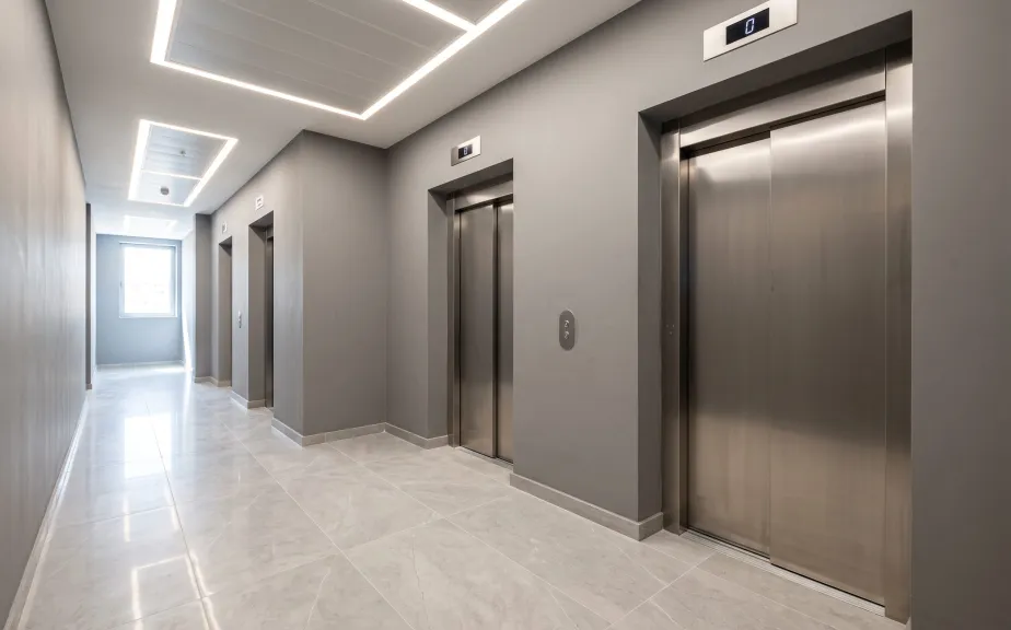 Refurbished office lift lobby with new stainless steel doors
